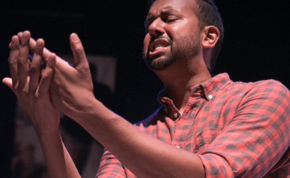 Andrew Prashad faces his own outstretched hands with great emotion.