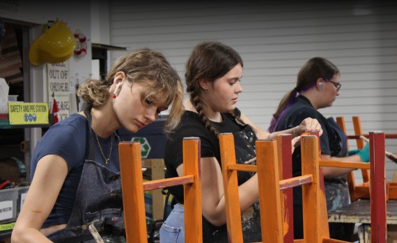 Young Artists in the Auburn - a group of students paint furniture in the Grand Theatre's Prop Shop.