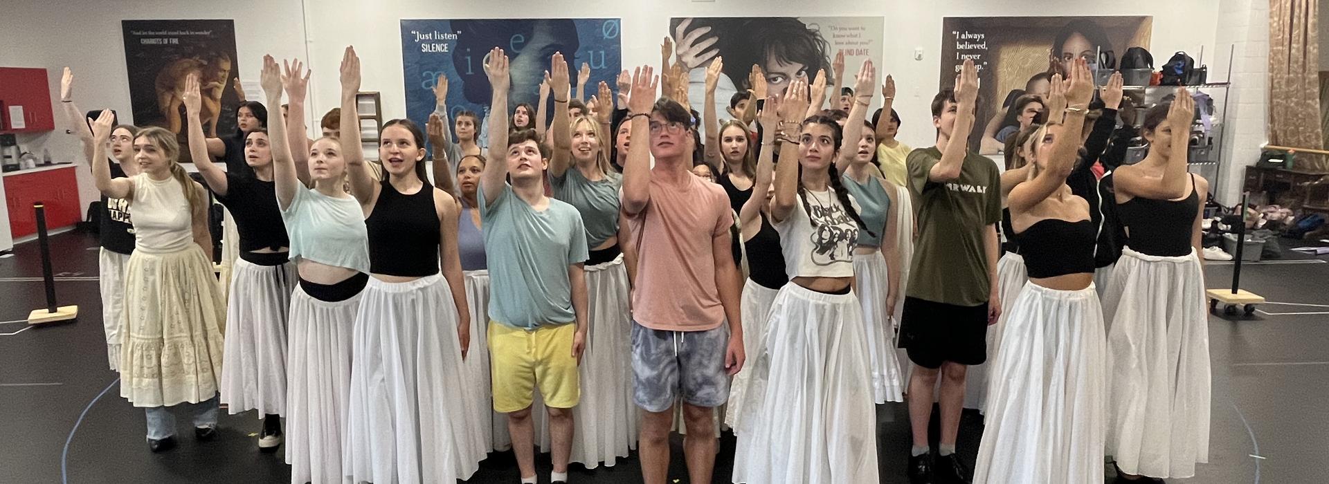 Cast of The Phantom of the Opera perform in the rehearsal hall.